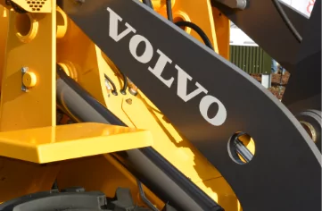 Volvo backhoe loader with labels.