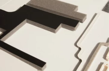 A set of custom black and white foam pieces on a white surface.