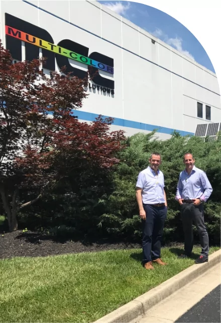 Two men standing in front of a building with medical labels.