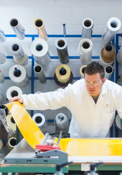 A man wearing a white coat specializing in custom label solutions.