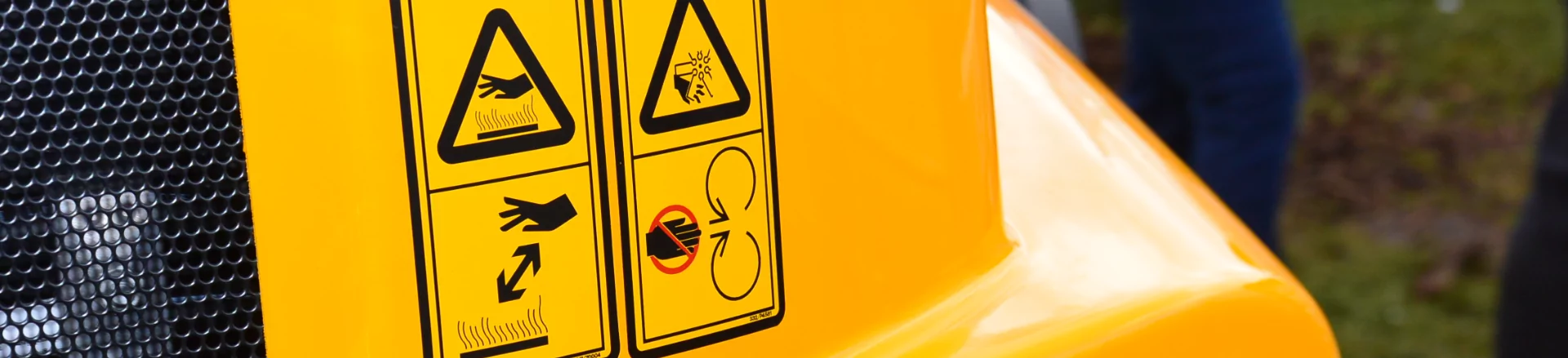 A close up of a yellow truck with custom labels on it.