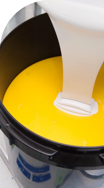 A yellow liquid is being poured into a bowl with custom labels.