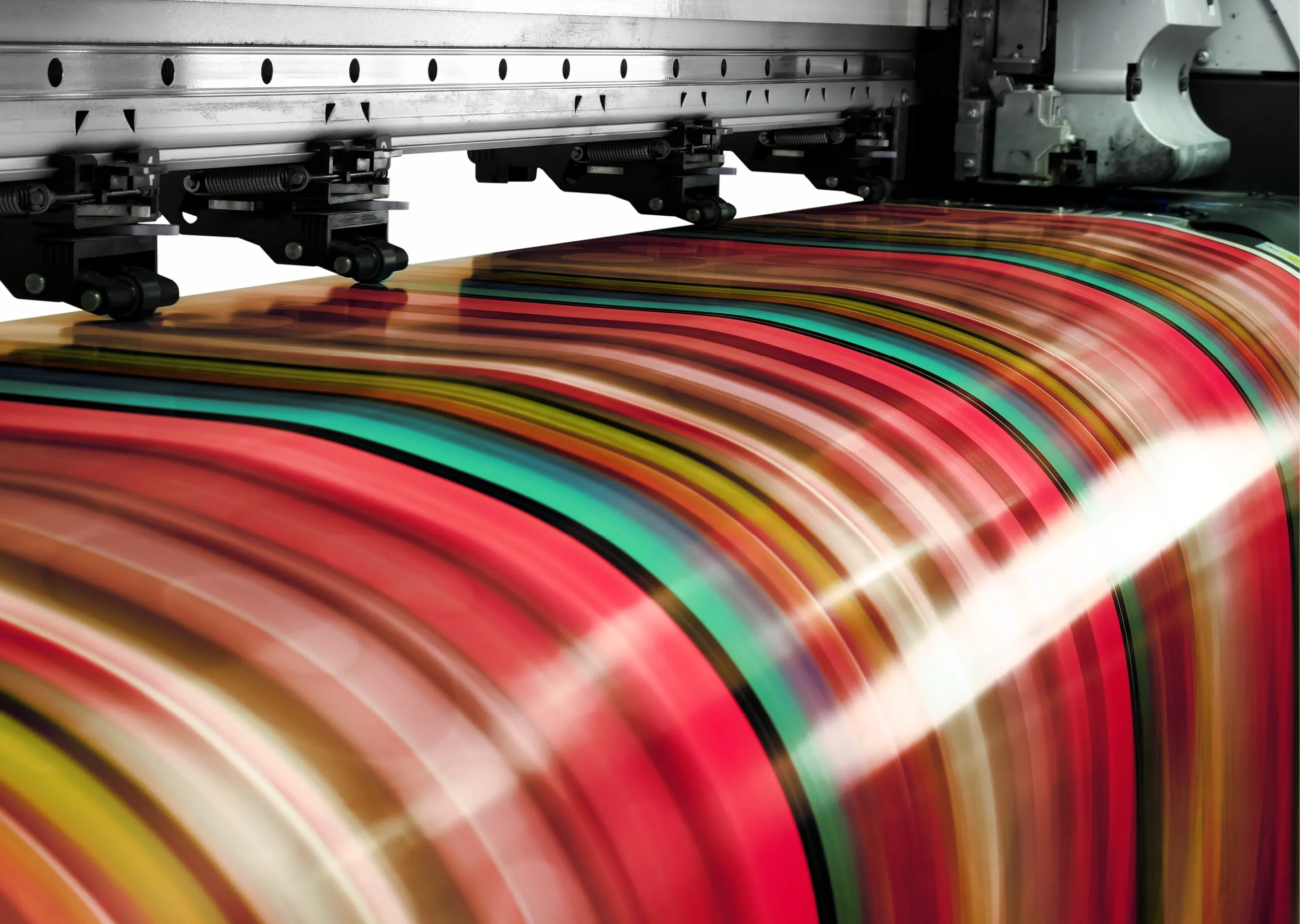 A close-up view of a large-format printer producing a sheet with vibrant, multicolored horizontal stripes.